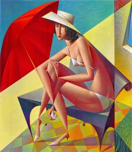 woman sitting on a beach under a red umbrella