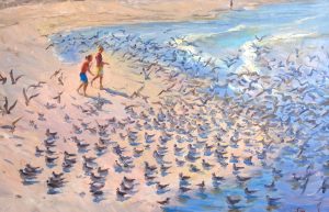 kids chasing birds on the beach
