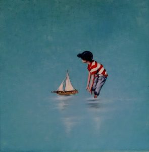 boy pushing sail boat