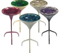Martini Table <br />
21.5”H x 12”W<br />
The most sought-after piece in the collection is this round mini conversation piece, fashioned from solid steel into a charming martini glass form. Champagne gold fragments ¬oat to the surface displaying movement in the depths of 8” resin. Finishing with customizable, playful multi-colored tones.<br />
