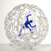 circular glass sculpture with figure inside