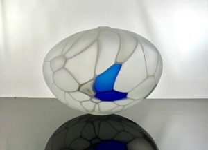 white and blue round vessel